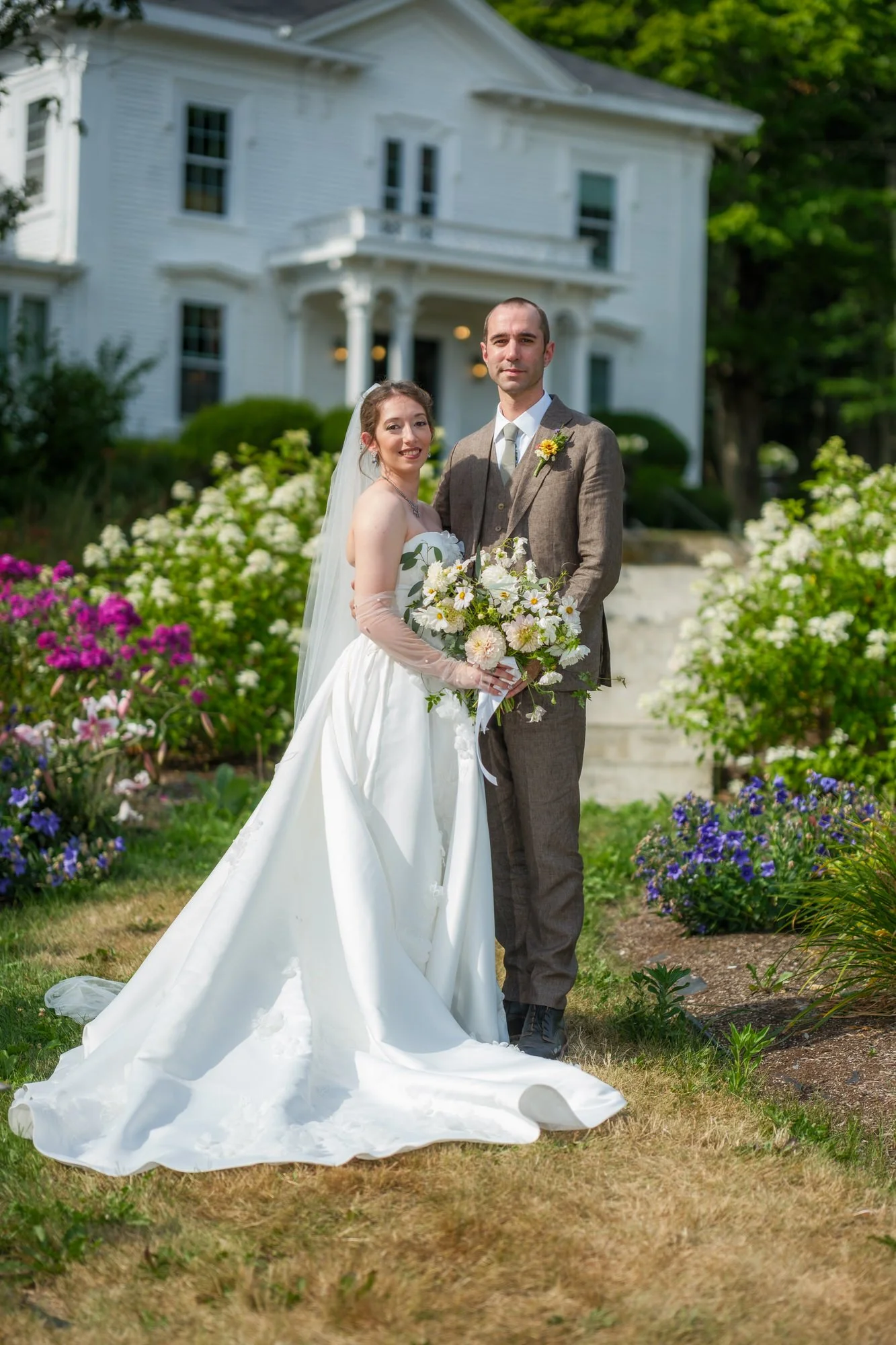 Bride and groom portrait with Belvedere House behind them