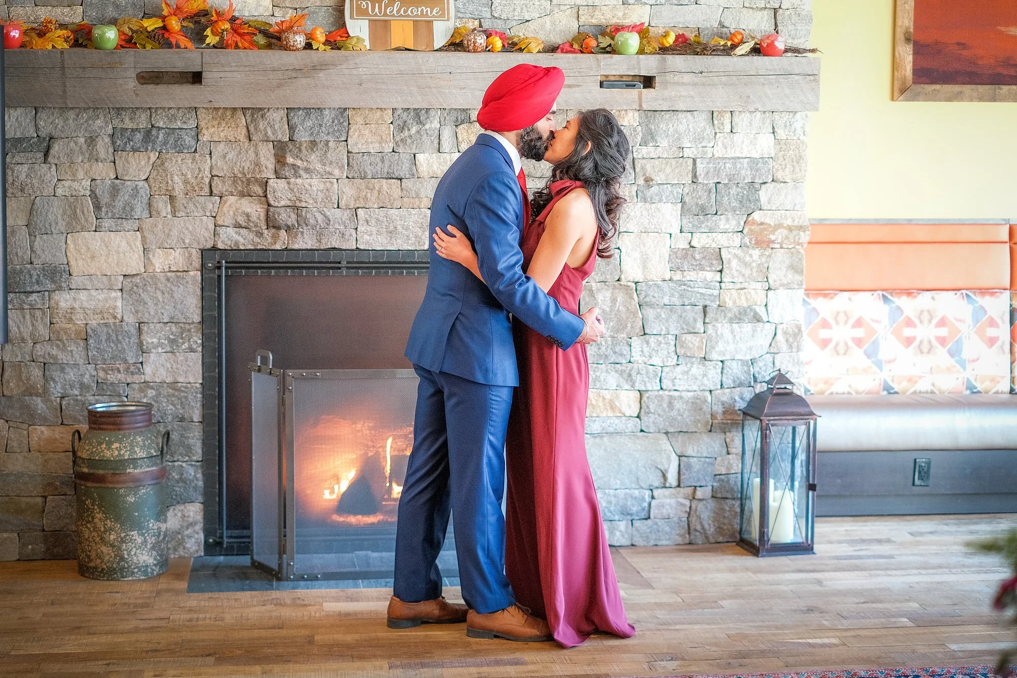 Couple sharing a romantic first kiss at the Glen House near Mt. Washington during their winter elopement