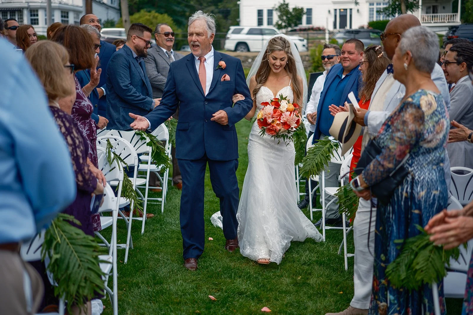 Bride walking down the outdoor aisle with her father at a York Maine summer wedding