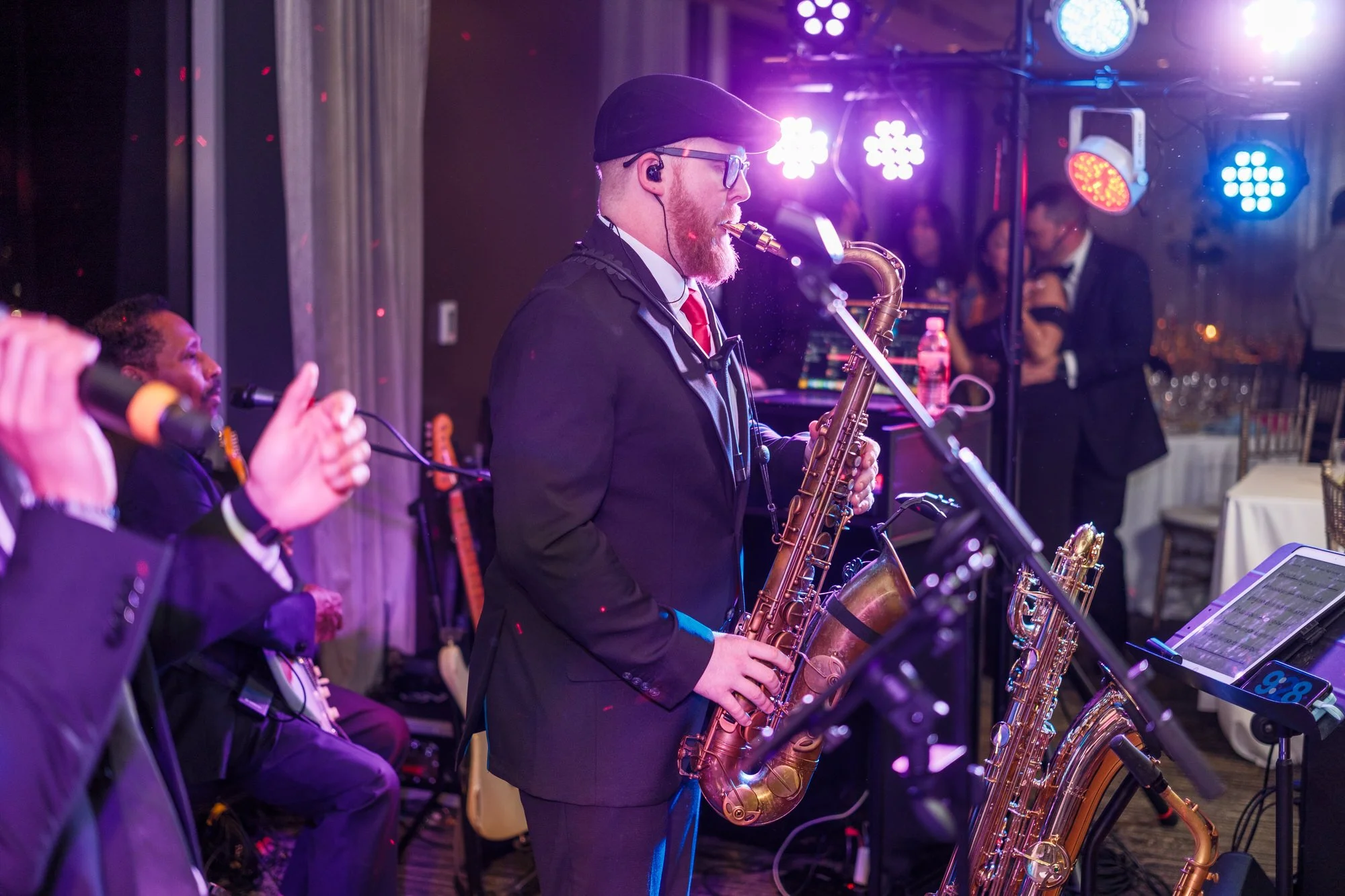 Guests dancing together on the crowded dance floor late in the evening at the UMass Club Boston Jewish wedding reception