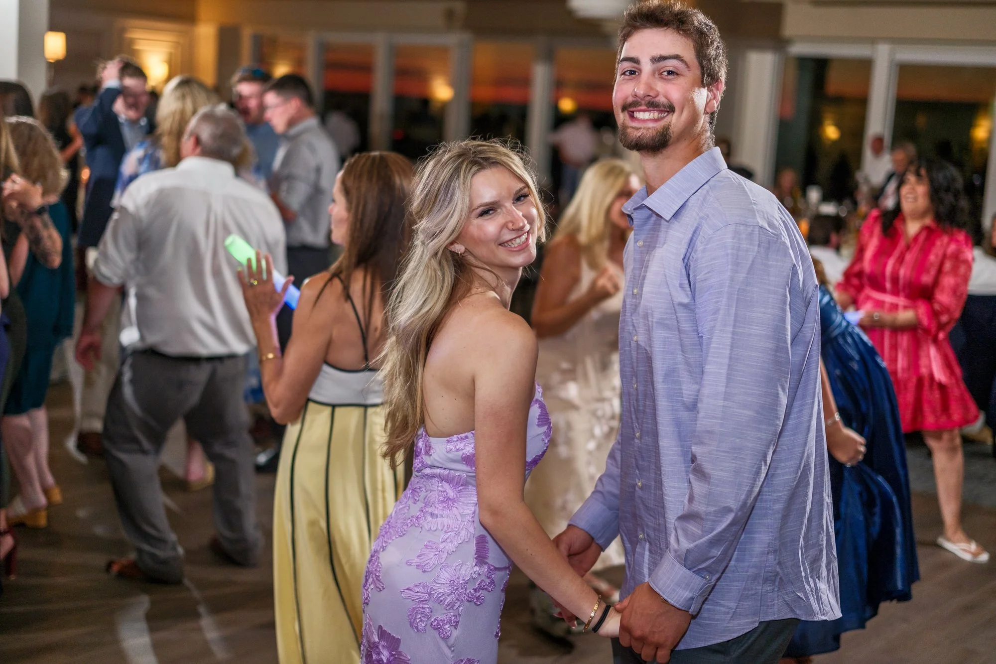 Wedding guest celebrating on the dance floor at Blue Ocean Event Center in Salisbury, MA.
