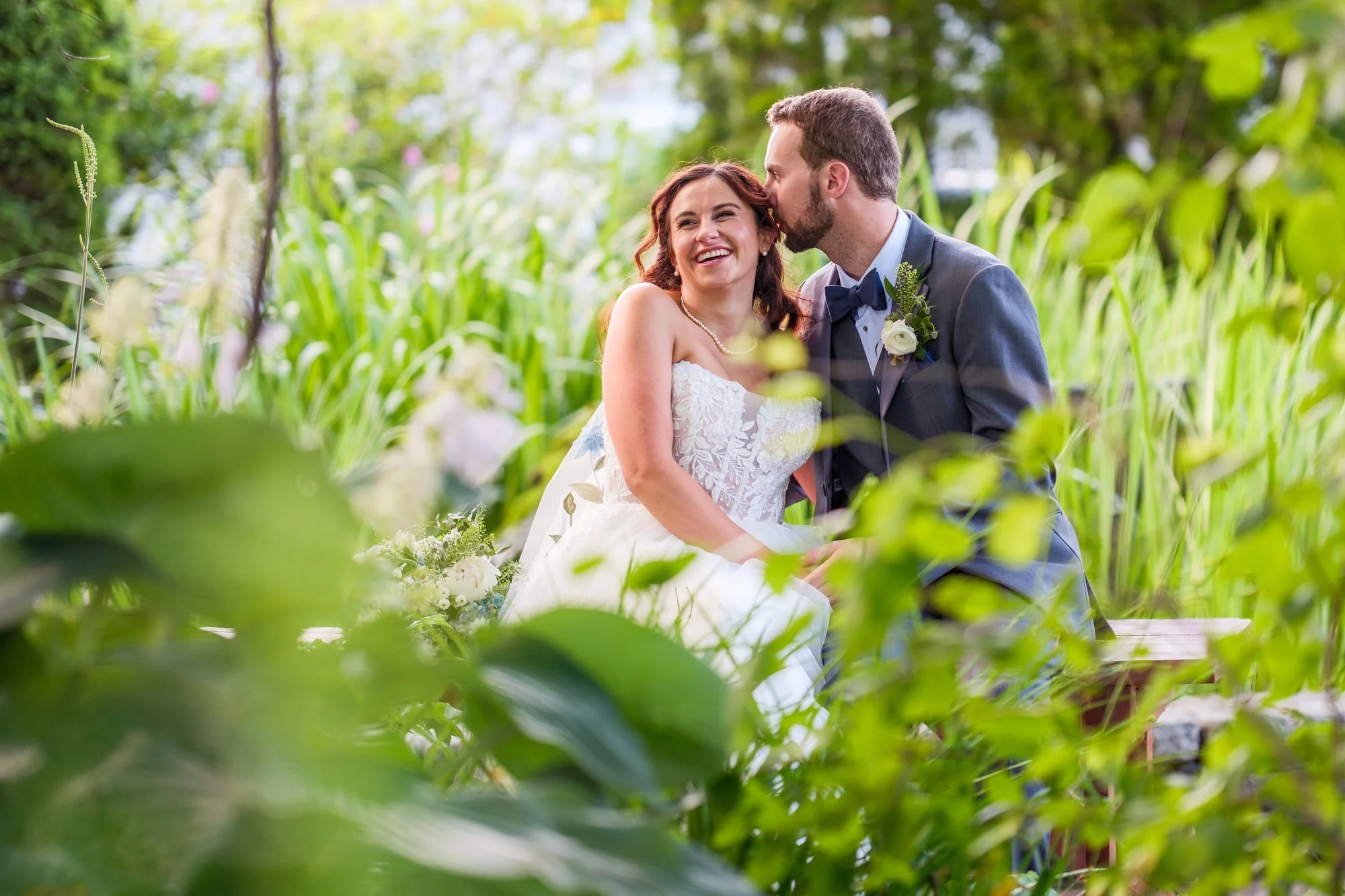Bride and groom laugh together in garden portraits at Lake Morey Resort