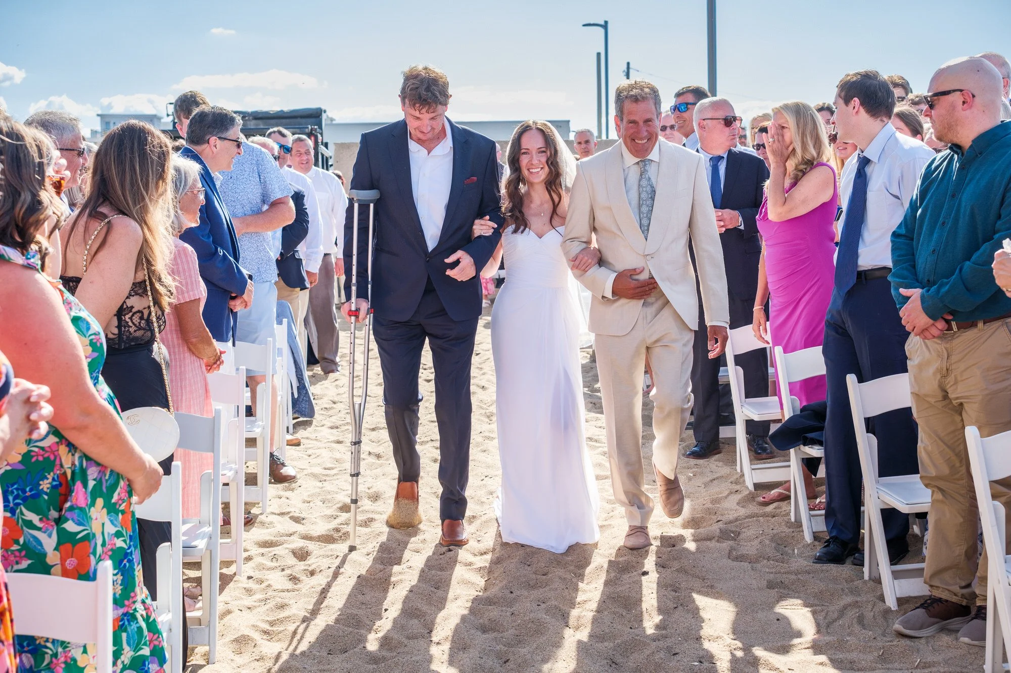 Bride walking down the sandy aisle during a Blue Ocean Event Center beach wedding in Salisbury, MA.