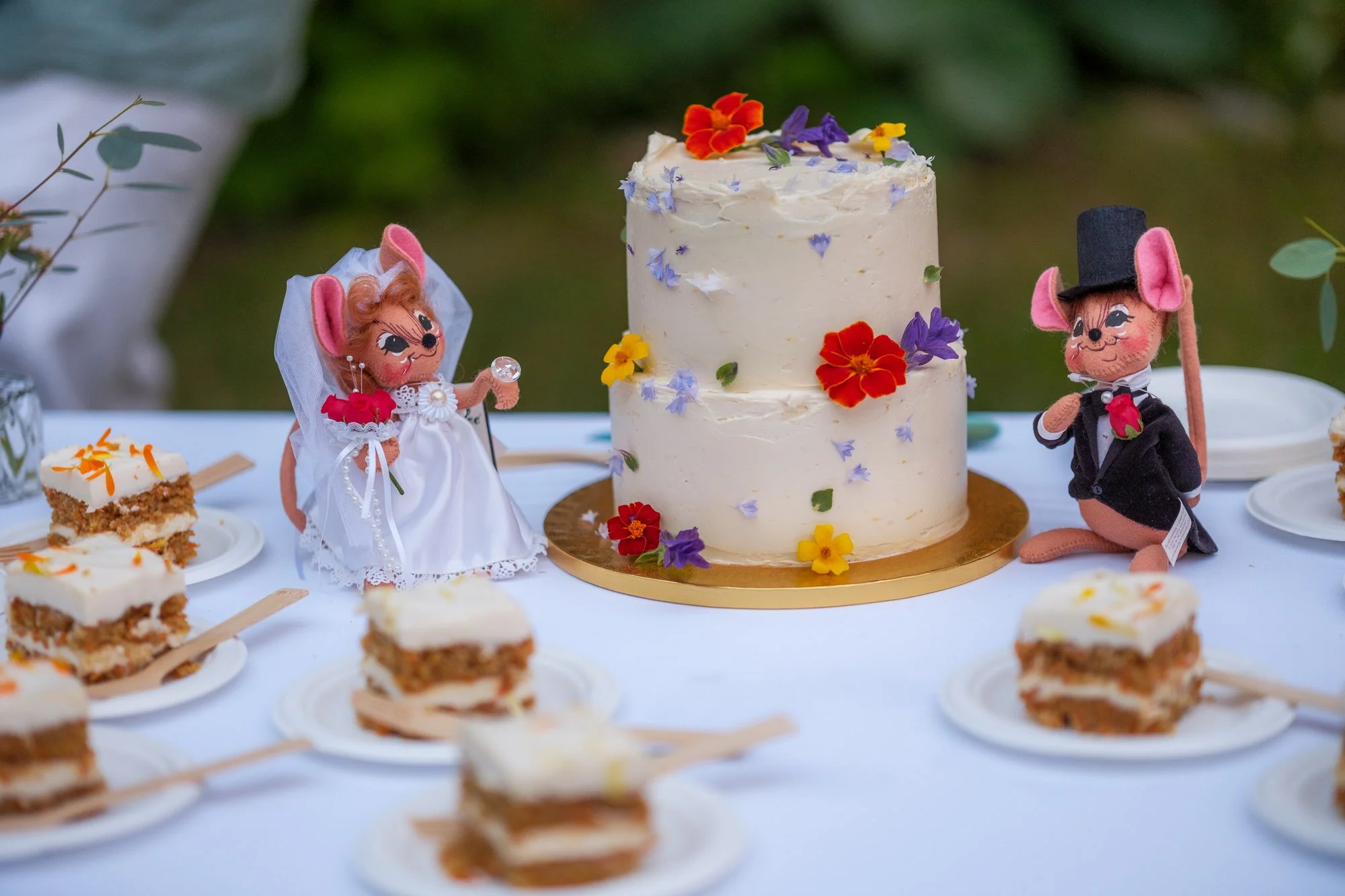 Wedding cake and dessert table with bride and groom figurines