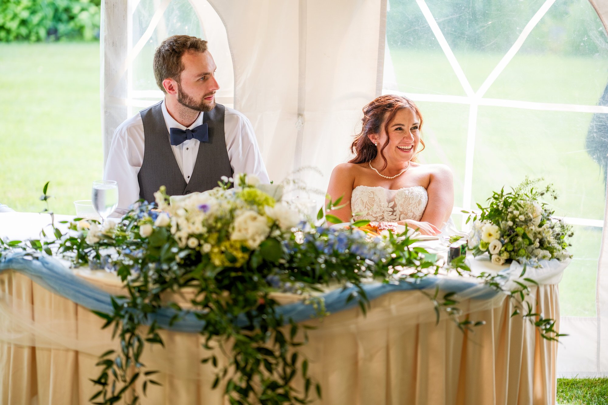 Bride and groom seated at sweetheart table for Lake Morey Resort reception
