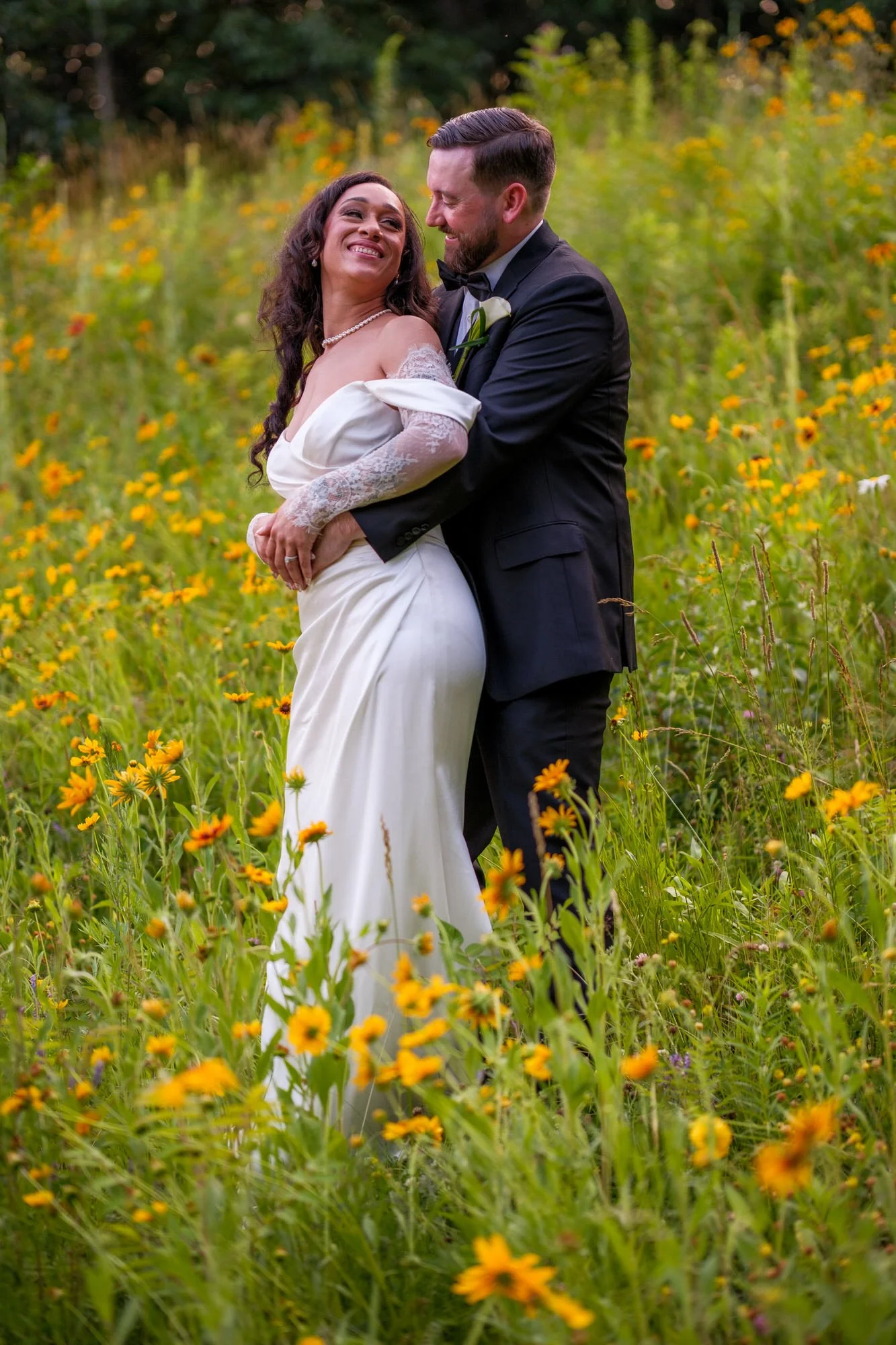 Romantic bride and groom portrait in wildflower field at Hyla Brook Estate