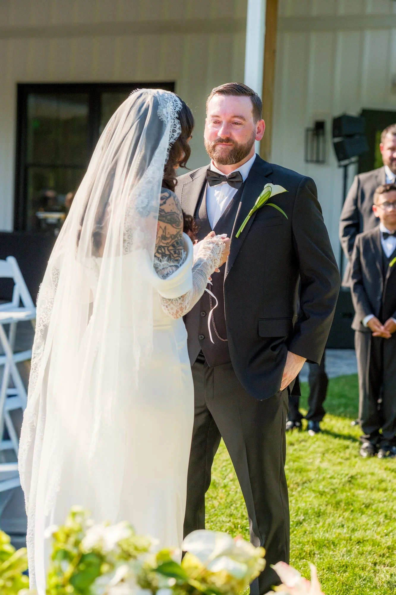 Groom smiling during outdoor wedding ceremony at Hyla Brook Estate