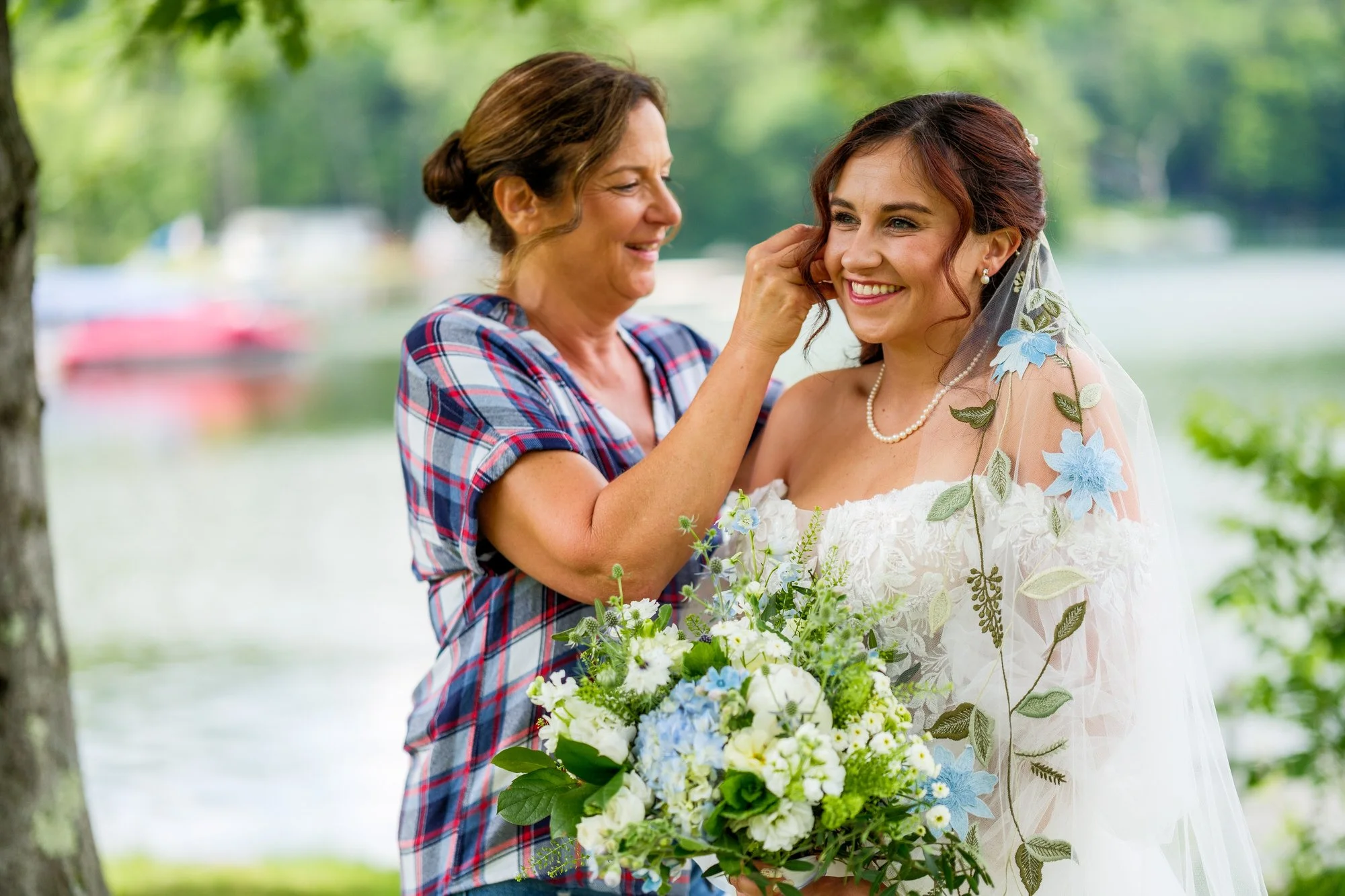 Mother adjusts the bride's veil before a Lake Morey Resort wedding in Vermont