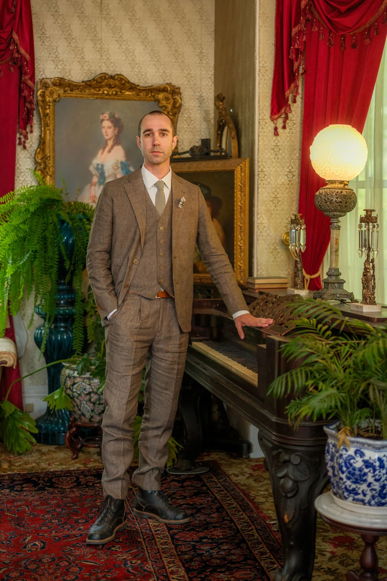 Groom portrait in a brown suit inside Belvedere House