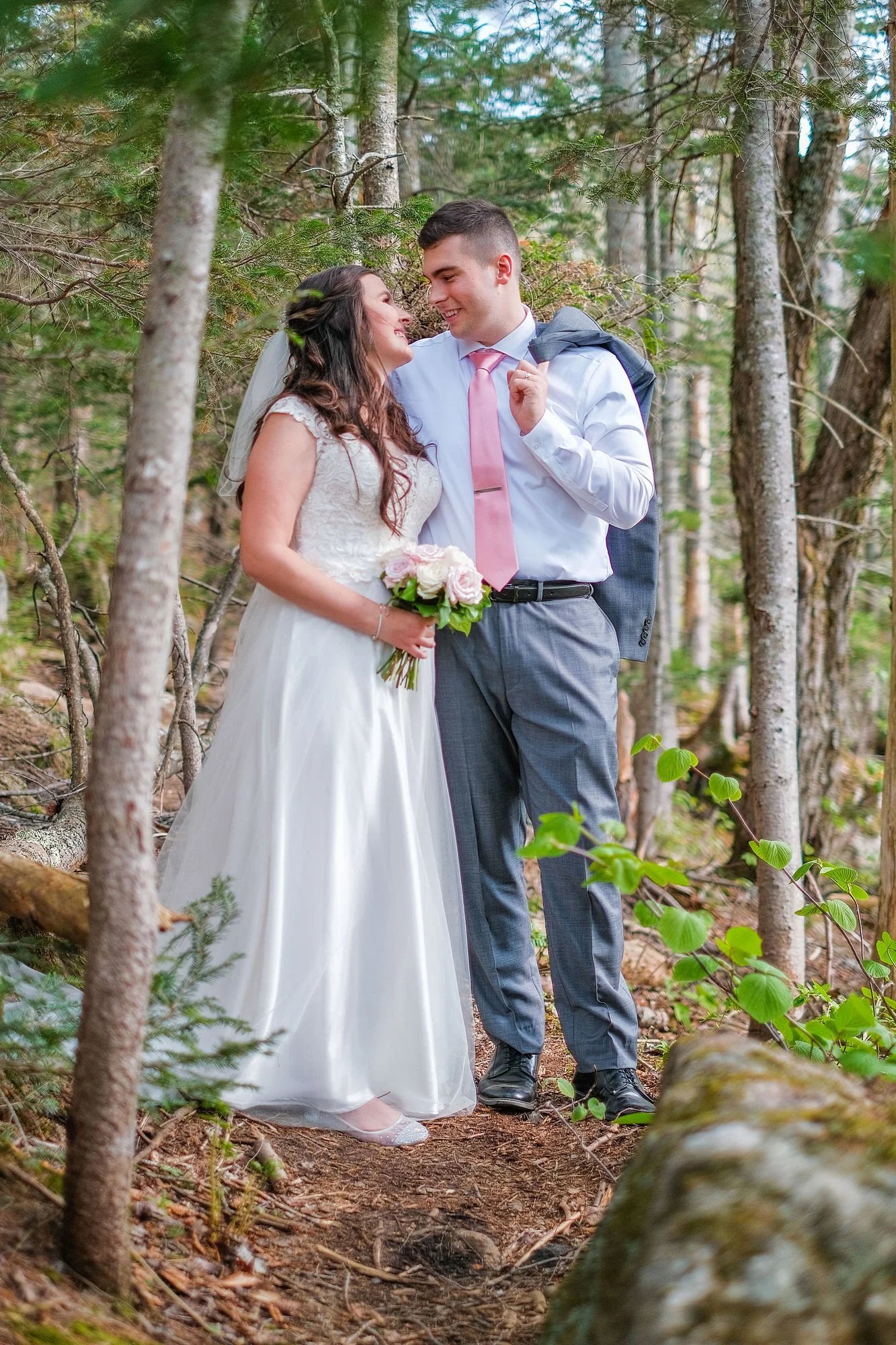 Bride and Groom posing for a portrait in Pinkham Notch forest in the White Mountains