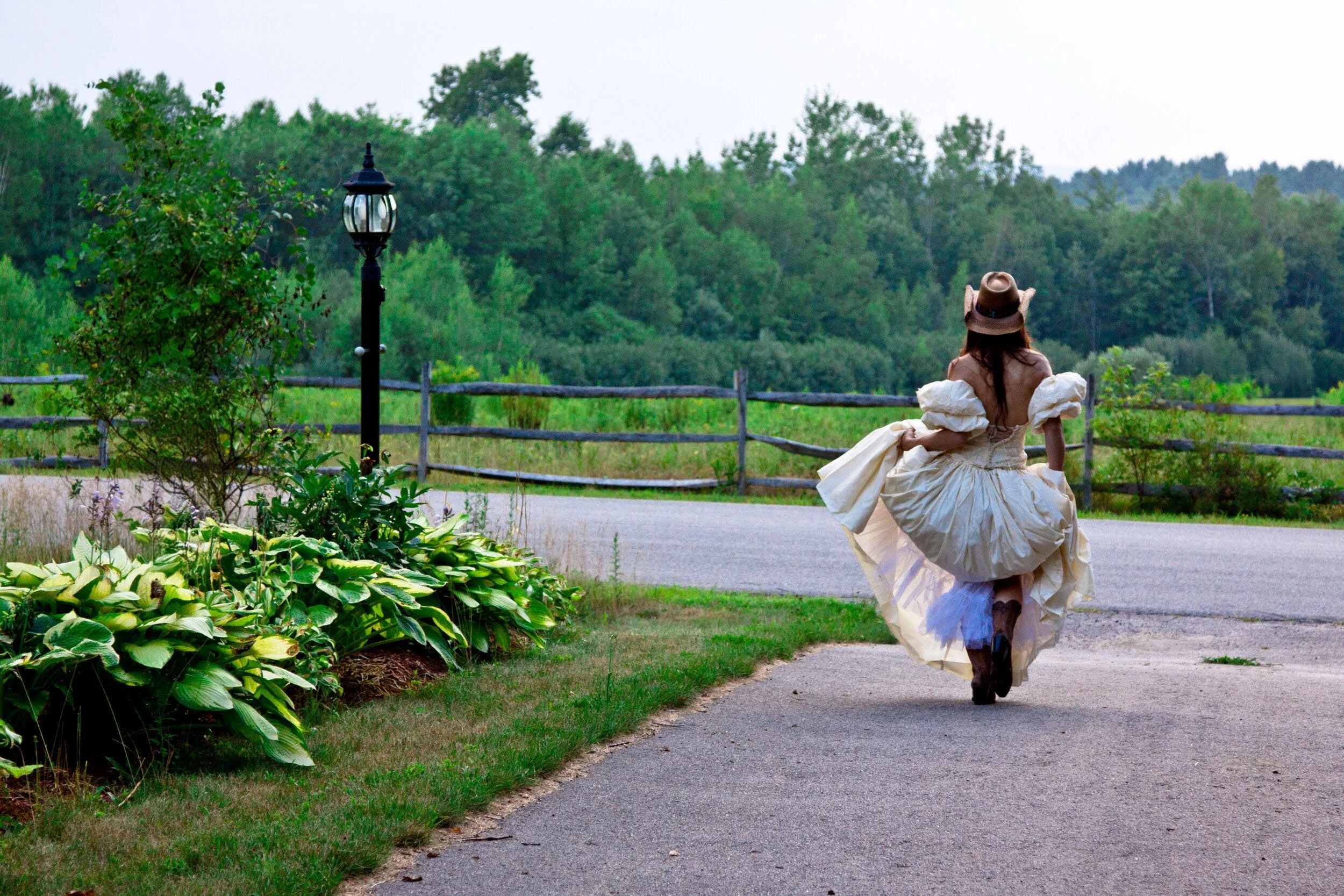 bride-running-cowboy-hat-country-wedding-nh-photographer.jpg