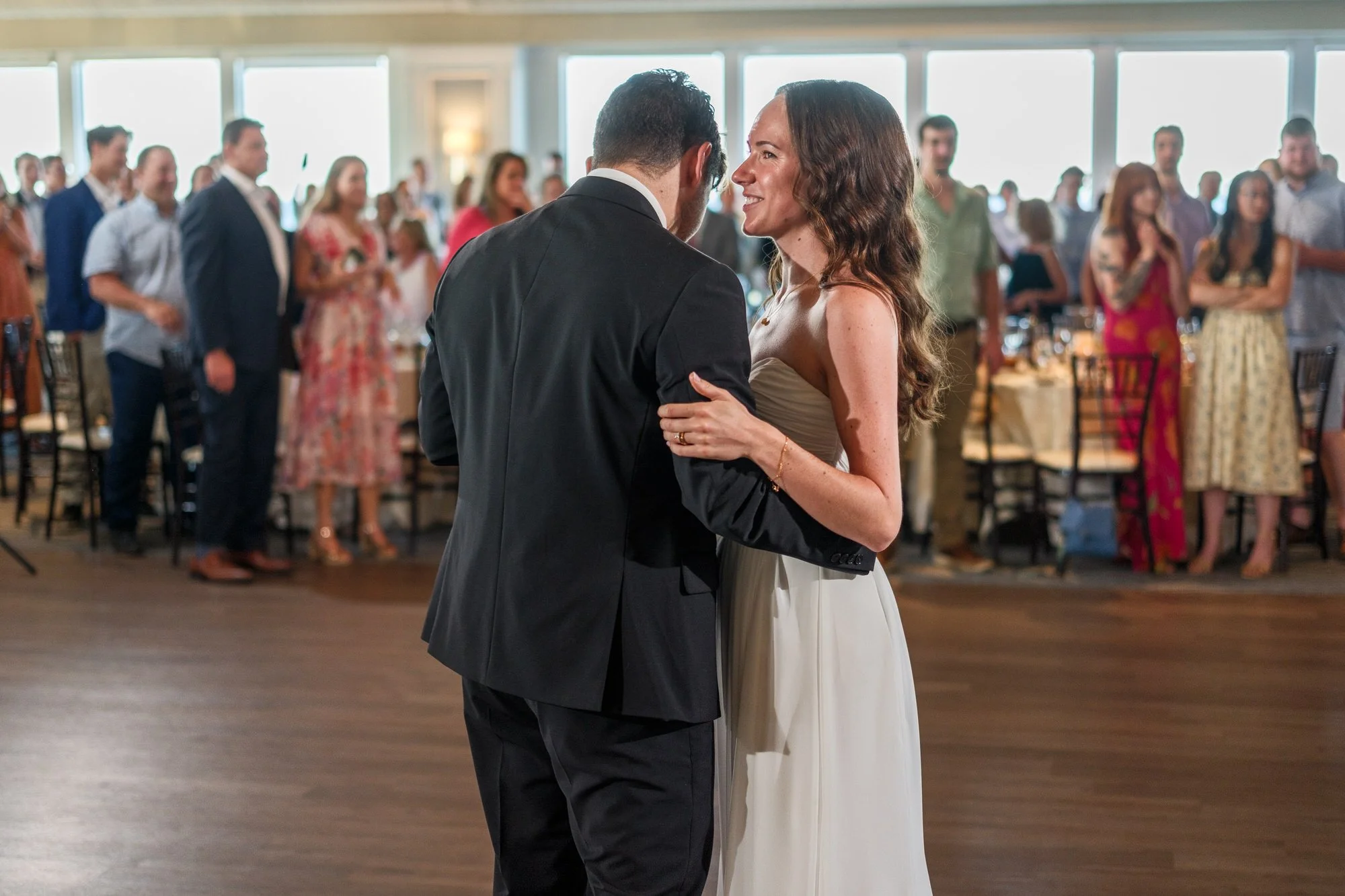 Bride sharing an emotional reception dance with groom at Blue Ocean Event Center.