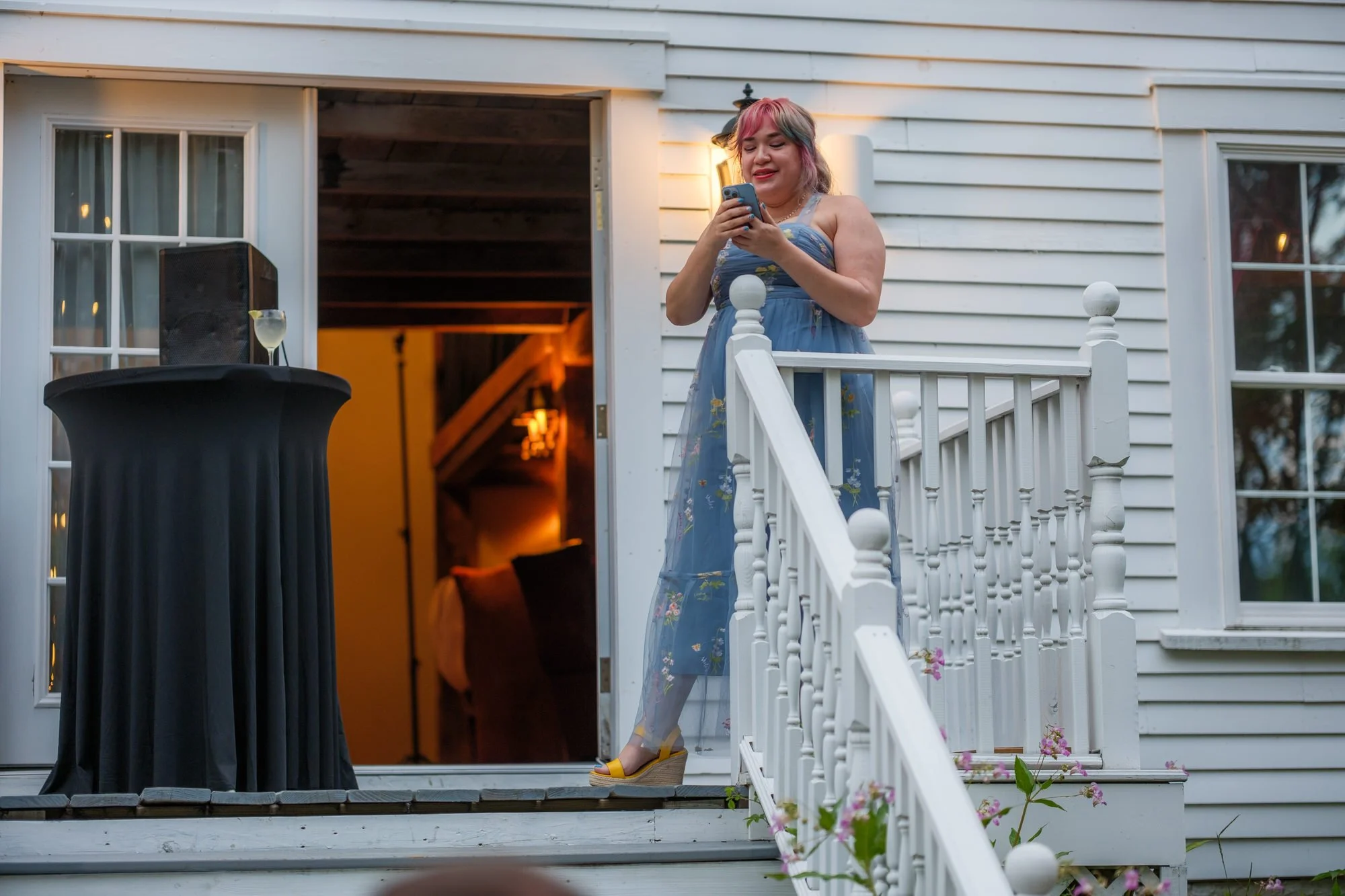 Wedding guest giving a toast from the porch steps