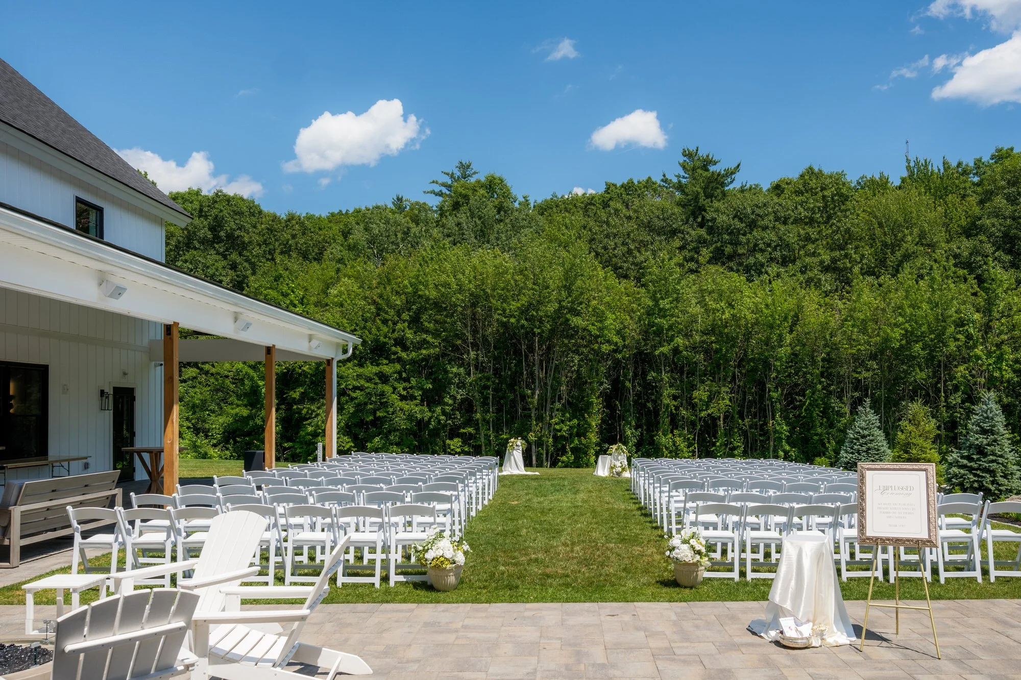 Outdoor ceremony setup with white chairs at Hyla Brook Estate in Derry, New Hampshire