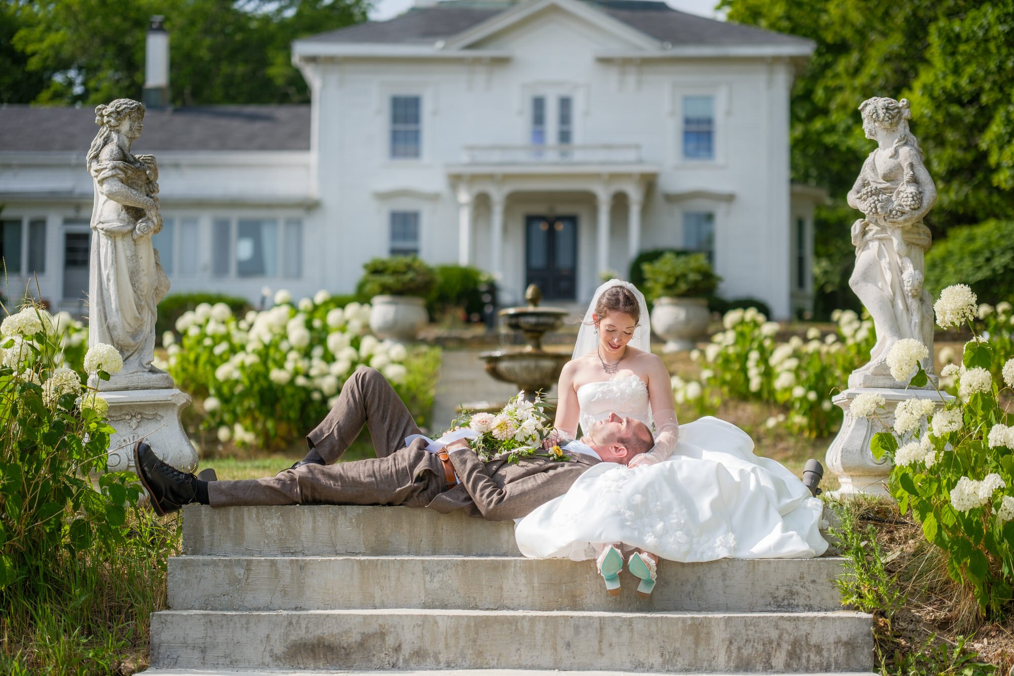 Couple relaxing on garden steps in front of Belvedere House