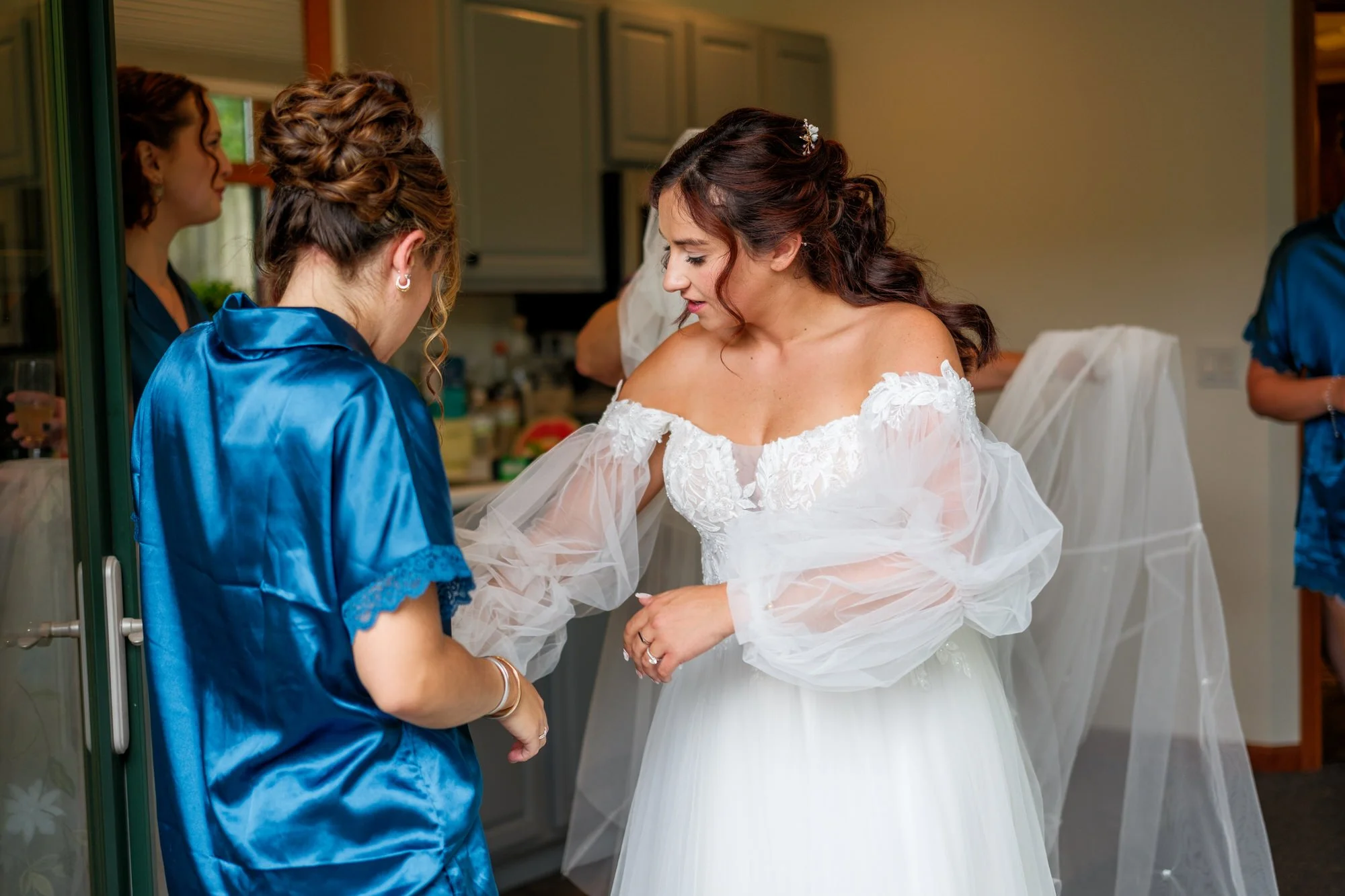 Bride getting ready in her wedding gown at Lake Morey Resort in Fairlee, Vermont