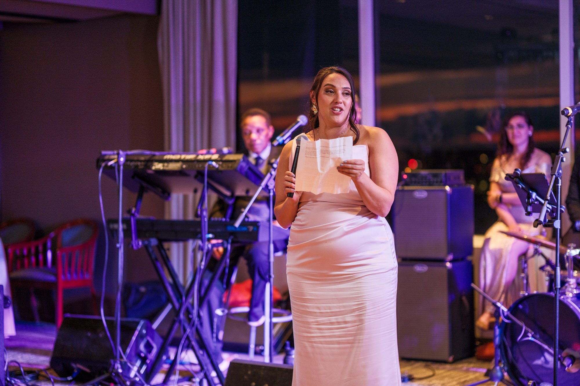 Bridesmaid delivering a heartfelt toast with microphone at the UMass Club Boston wedding reception