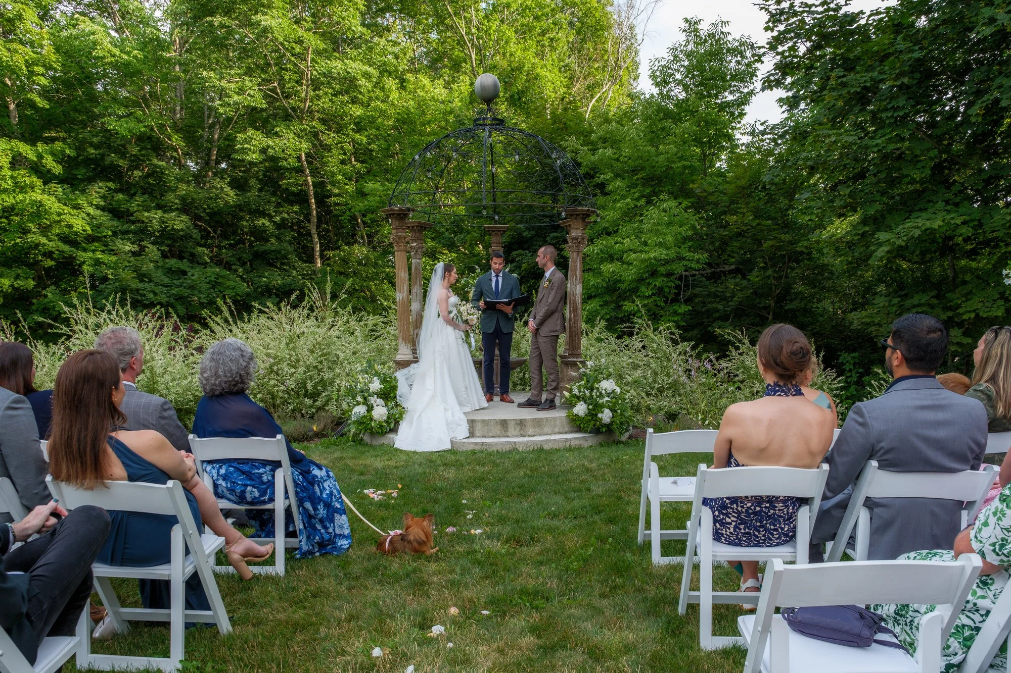 Guests watching an outdoor wedding ceremony at Belvedere House