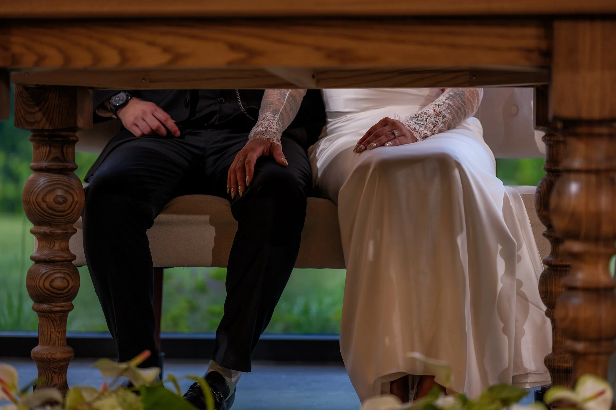 Bride and groom seated together at sweetheart table at Hyla Brook Estate