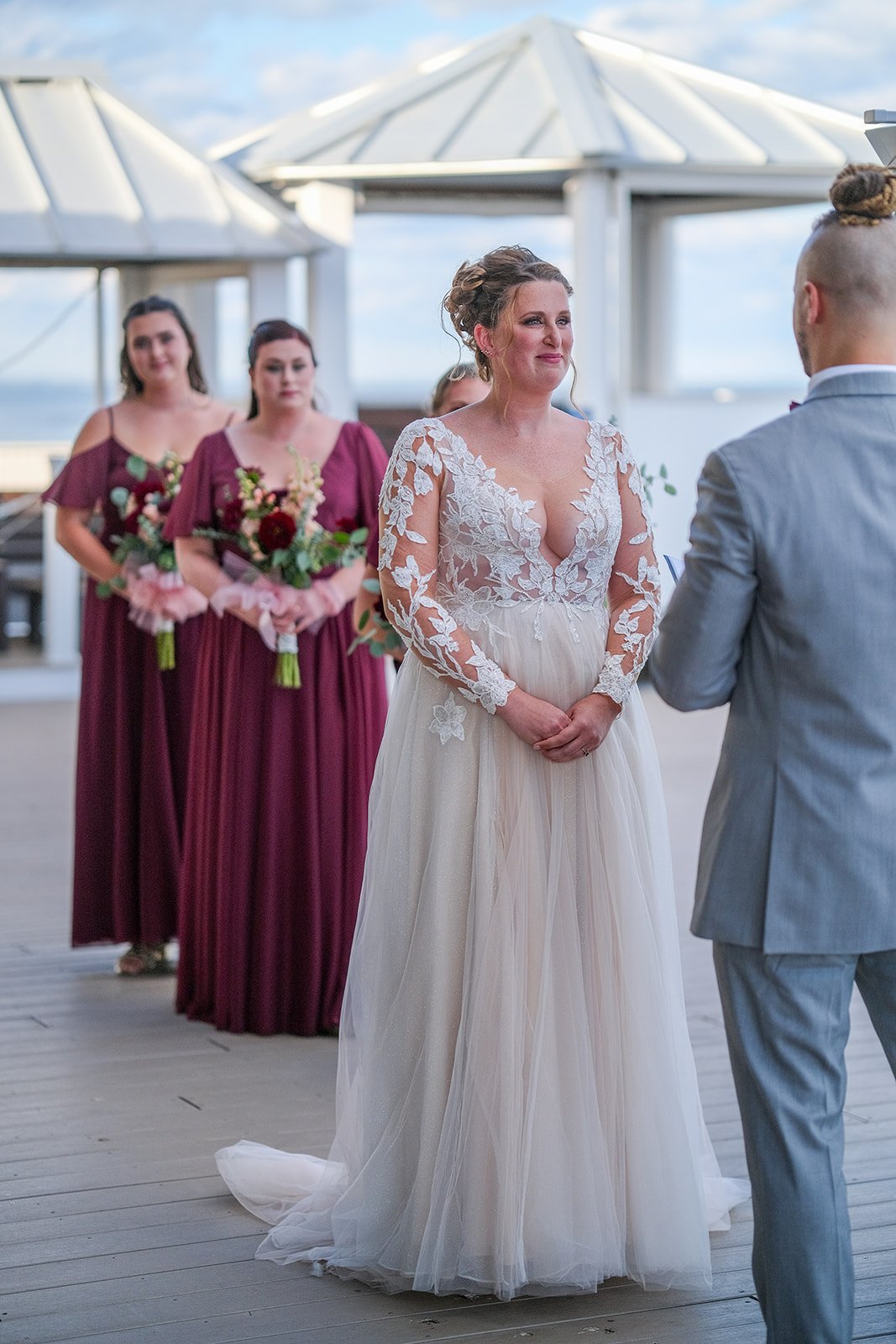 Emotional bride tearing up during wedding vows on the oceanfront deck at Blue Ocean Event Center, Salisbury Beach MA