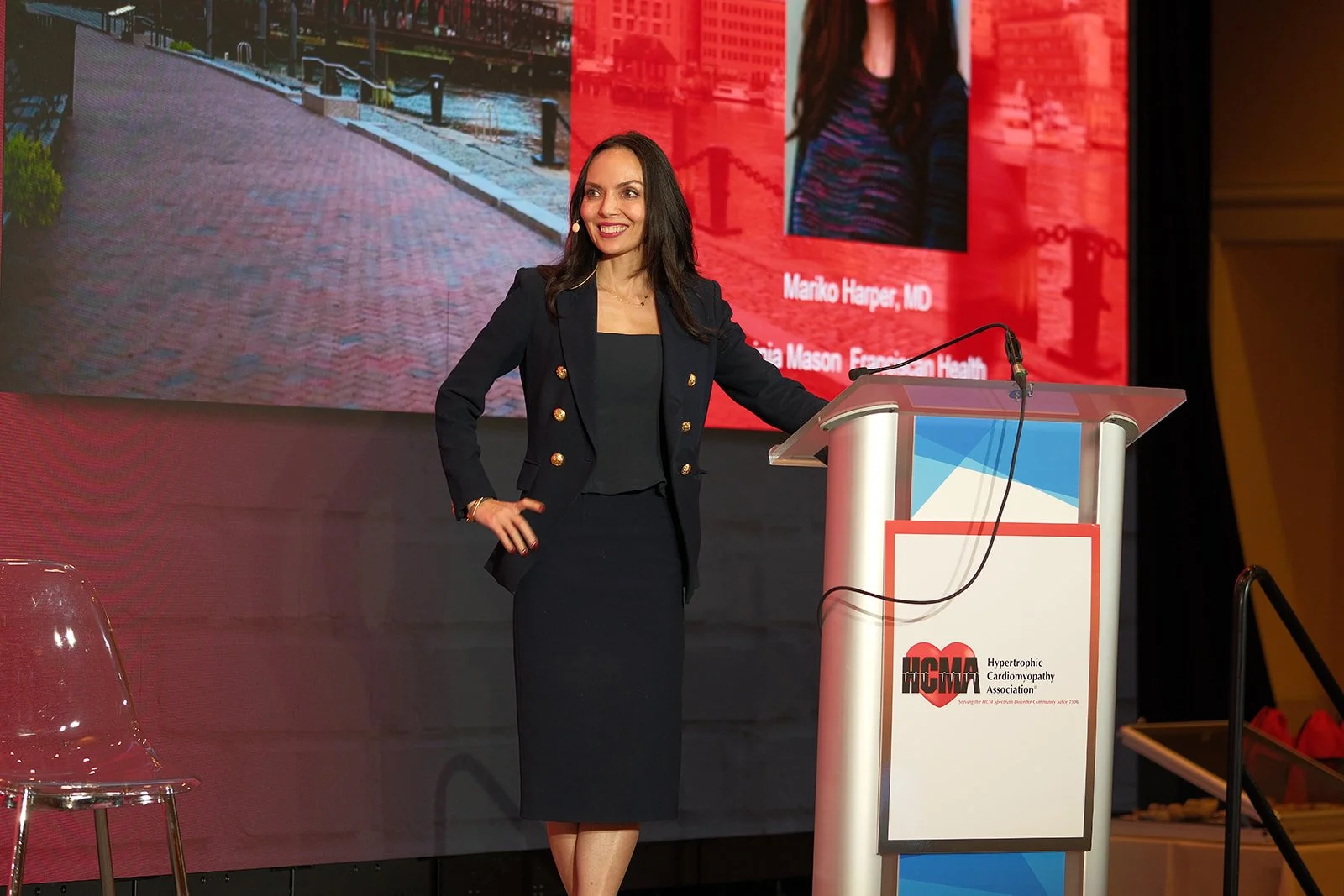 Confident keynote presenter stands at the HCMA podium during the 2024 Annual Patient Meeting at Boston Seaport Hotel