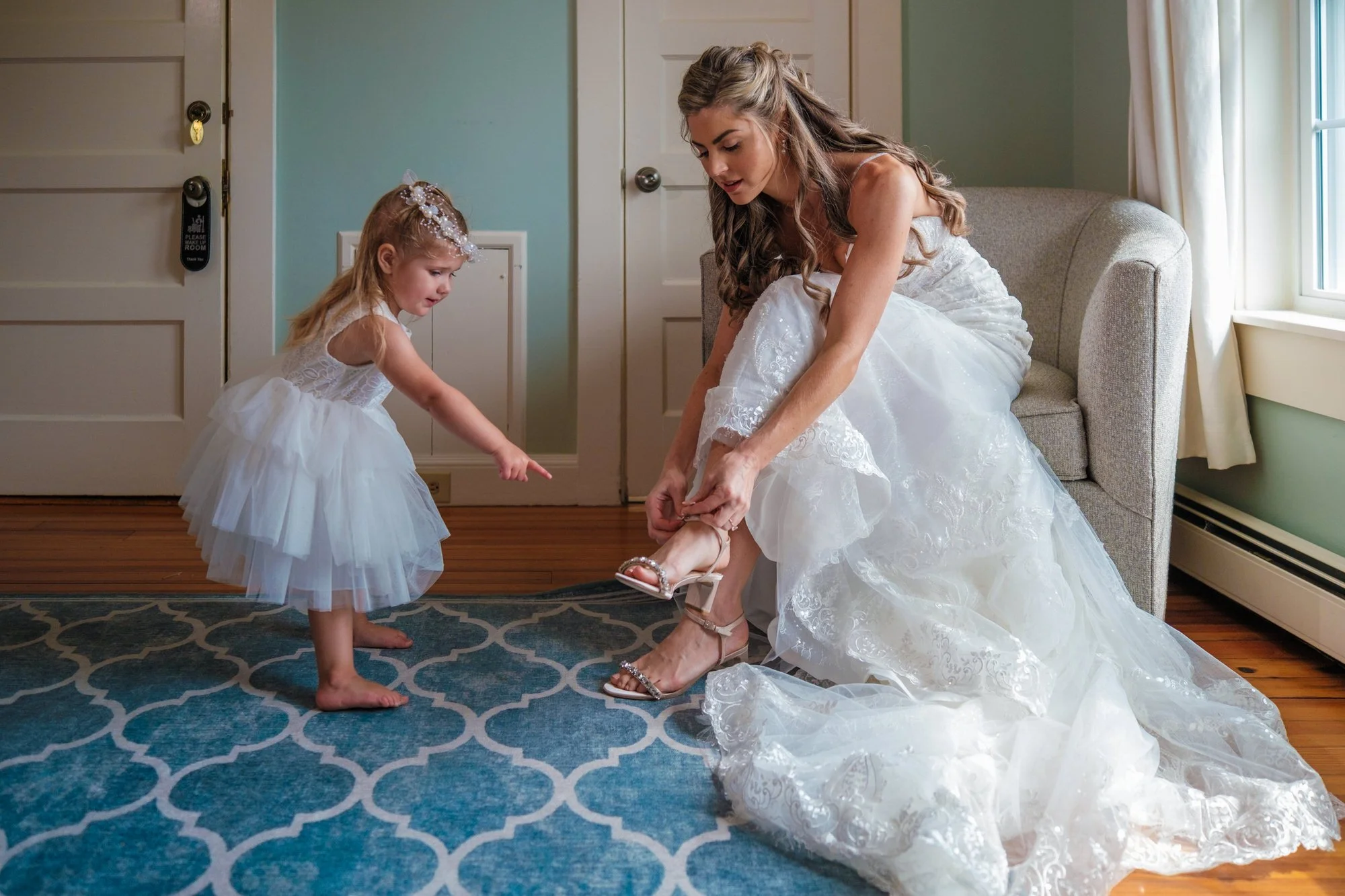Flower Girl helping the bride put on her shoe
