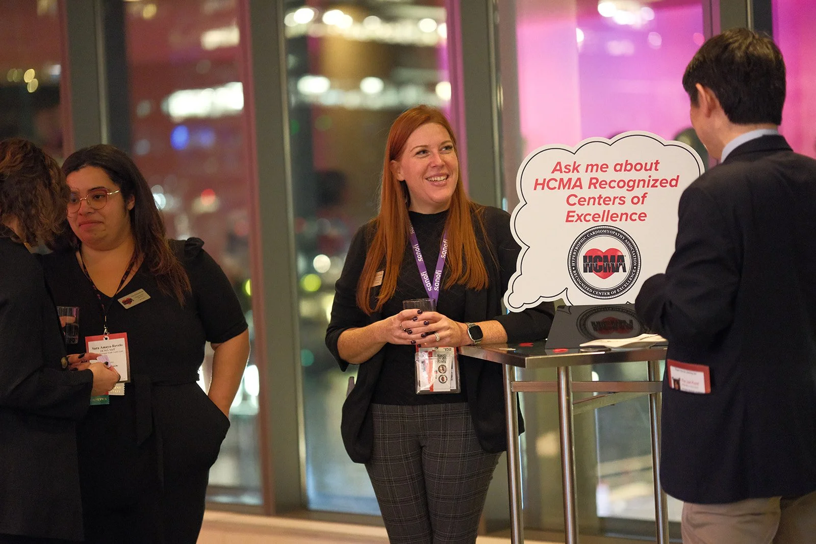HCMA staff member at the Recognized Centers of Excellence booth during the 2024 Annual Patient Meeting in Boston