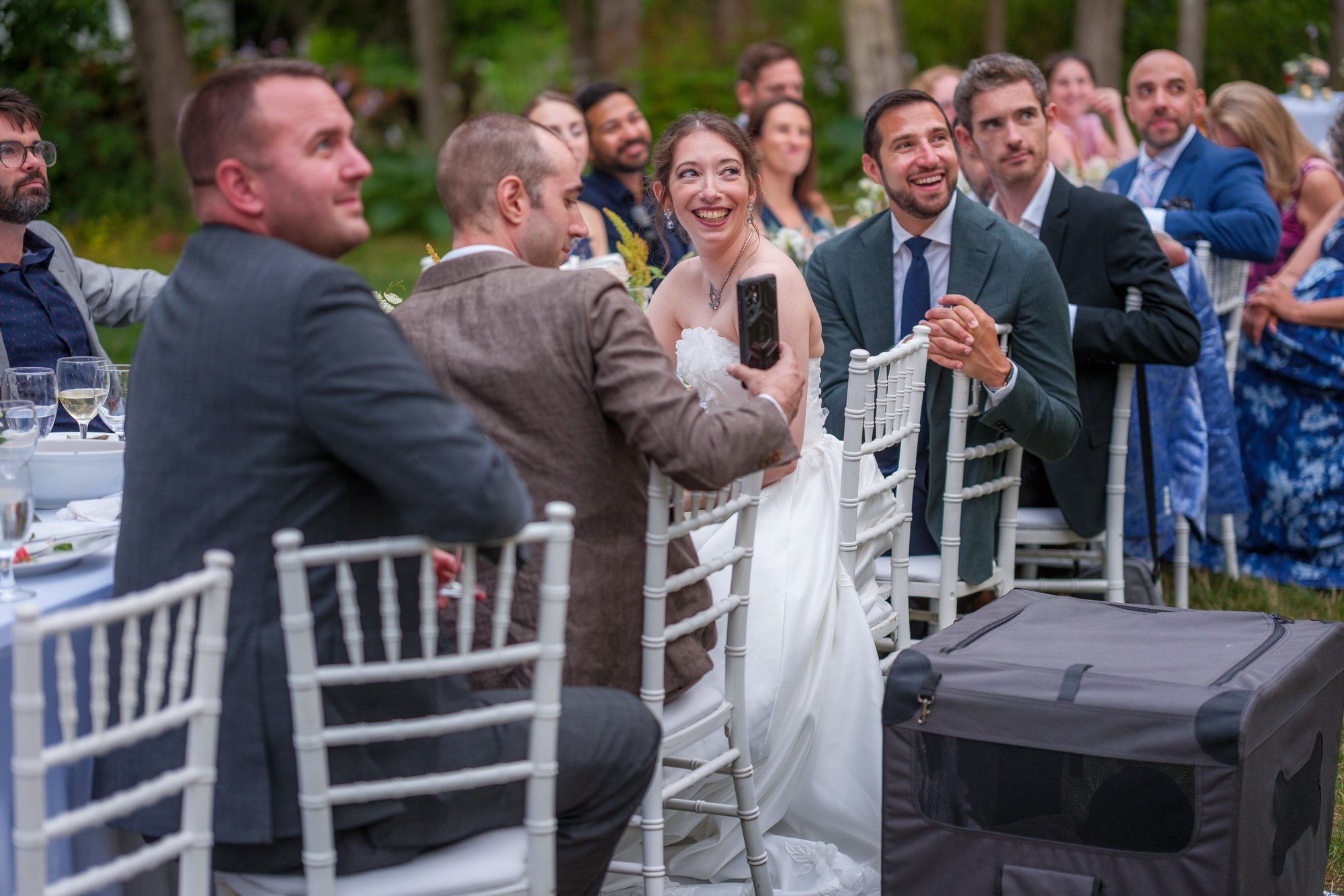 Reception guests reacting during speeches at dinner