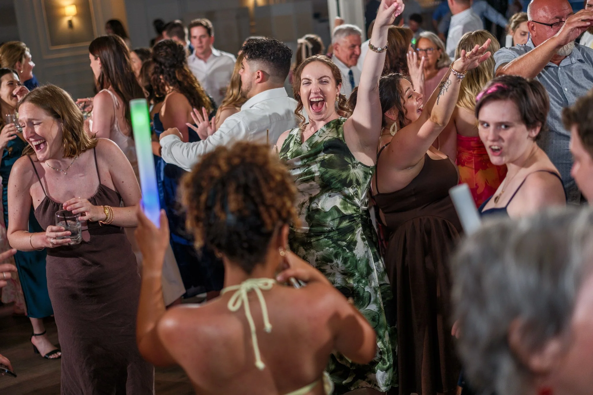 Wedding guests singing and dancing at a Blue Ocean Event Center reception in Salisbury, MA.