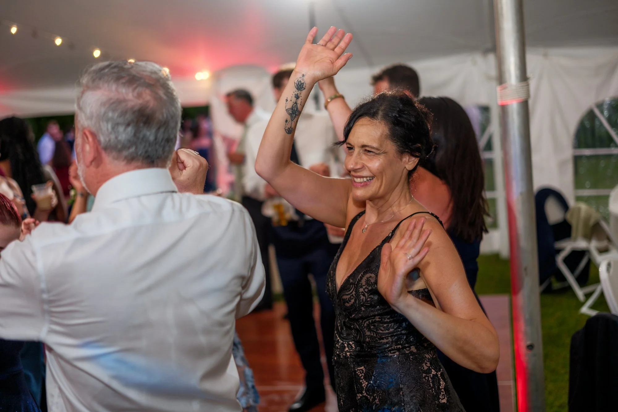 Guests dancing under warm reception lights at Lake Morey Resort wedding