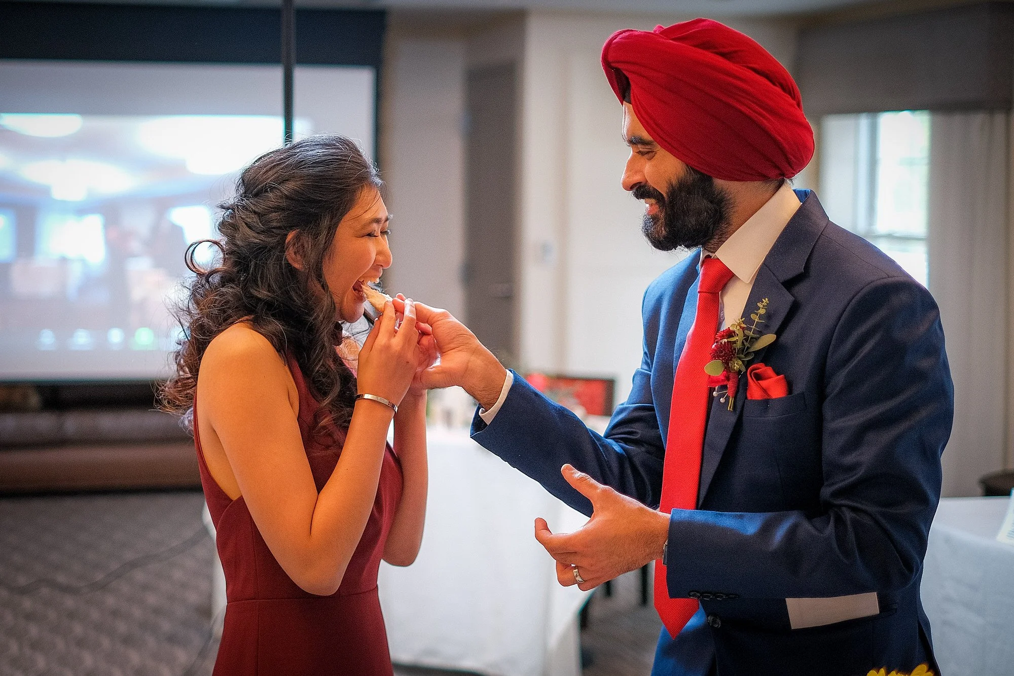Intimate elopement ceremony moment for a couple in front of a snowy mountain backdrop near Mt. Washington, NH in January