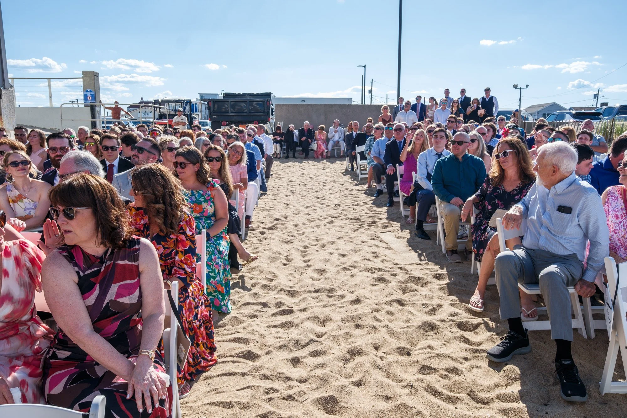 Bride walking down the sandy aisle during a Blue Ocean Event Center beach wedding in Salisbury, MA.