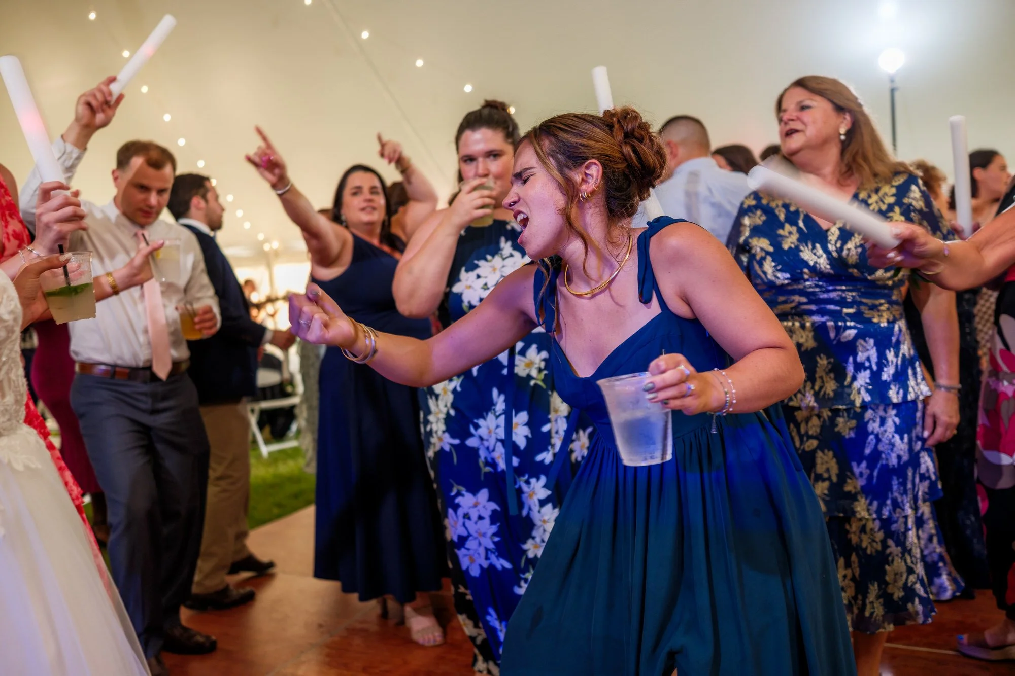 Wedding guests dance under tent lights at Lake Morey Resort reception