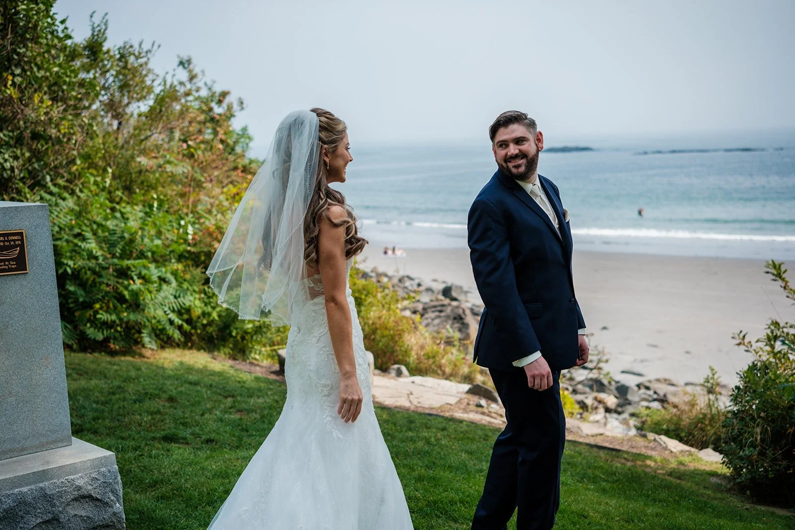 Groom's first look reaction on a bluff overlooking York Maine beach at summer wedding