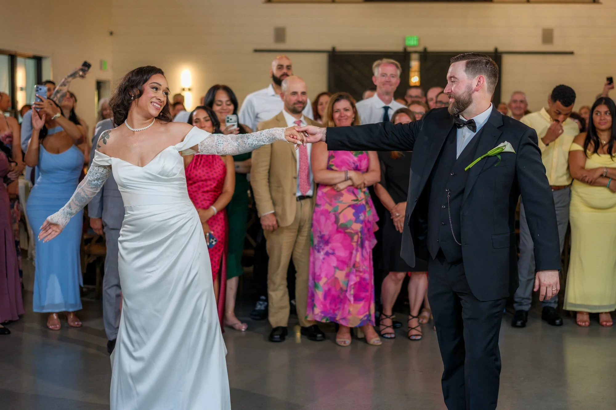 Bride and groom dancing as guests watch at Hyla Brook Estate reception
