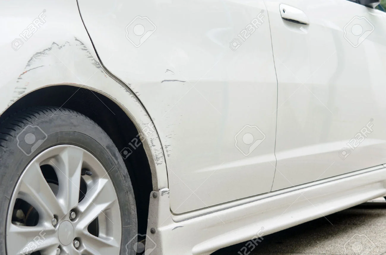 29714081-Car-paint-scratched-at-the-door-and-the-rubber-out-of-focus--Stock-Photo.jpg
