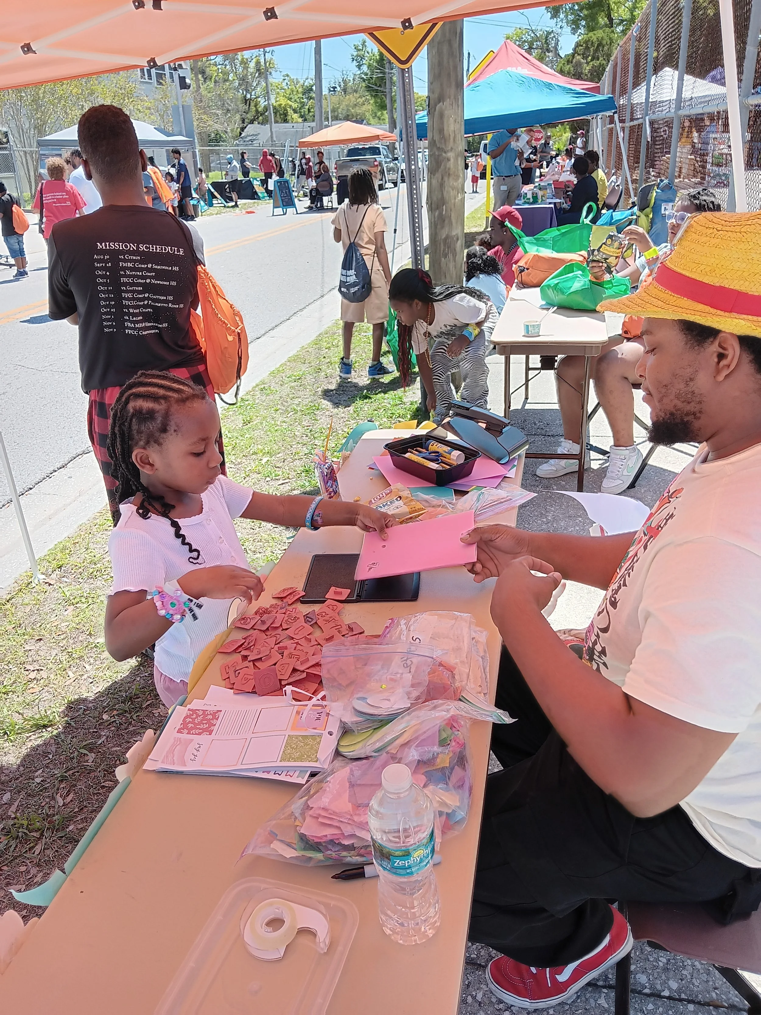  Helping youth with activity at LIT Block Party&nbsp; 