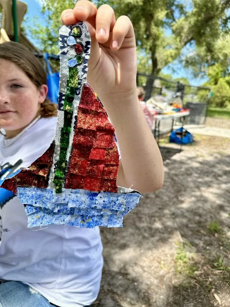 child holding their fabric collage
