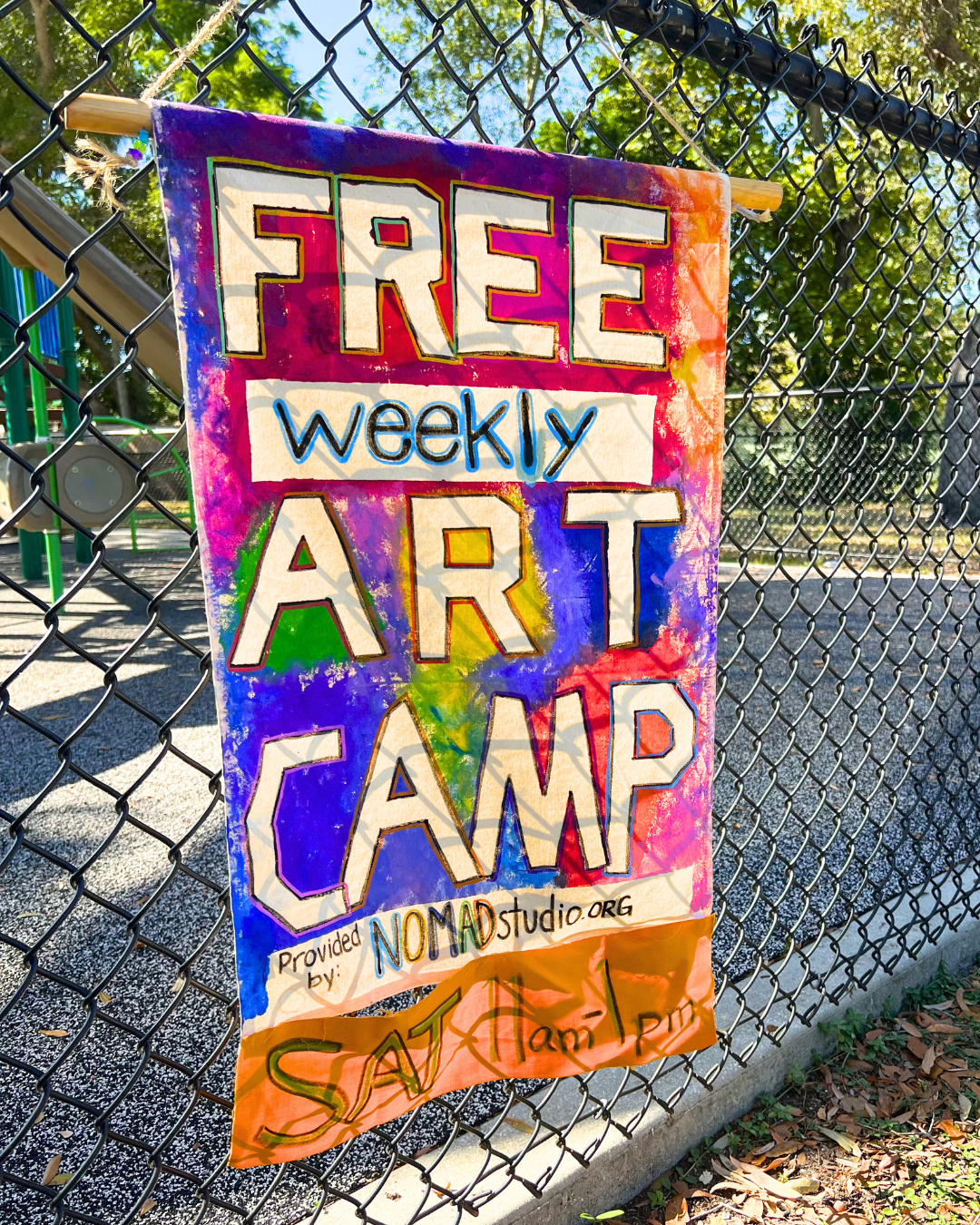 Colorful sign saying Free weekly art camp. Provided by NOMADstudio.org. Sat 11am-1pm