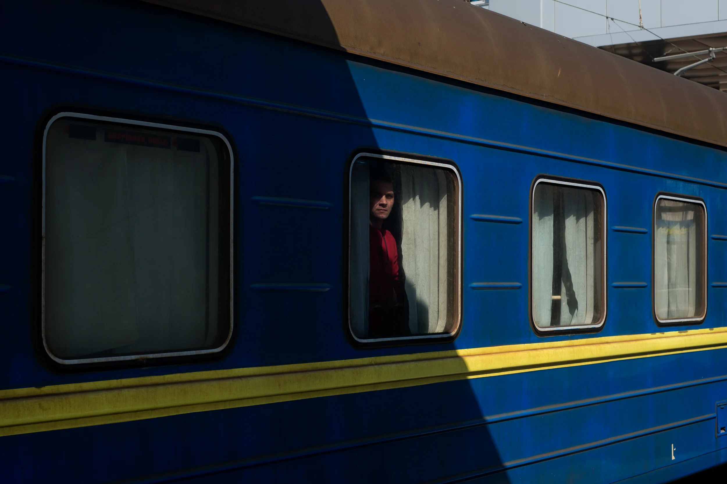 A man peers out of his train car at the train station in the Crimean city of Simferopol on March 15, 2014. Some people have fled Crimea for fear of violence during the referendum vote to join Russia.