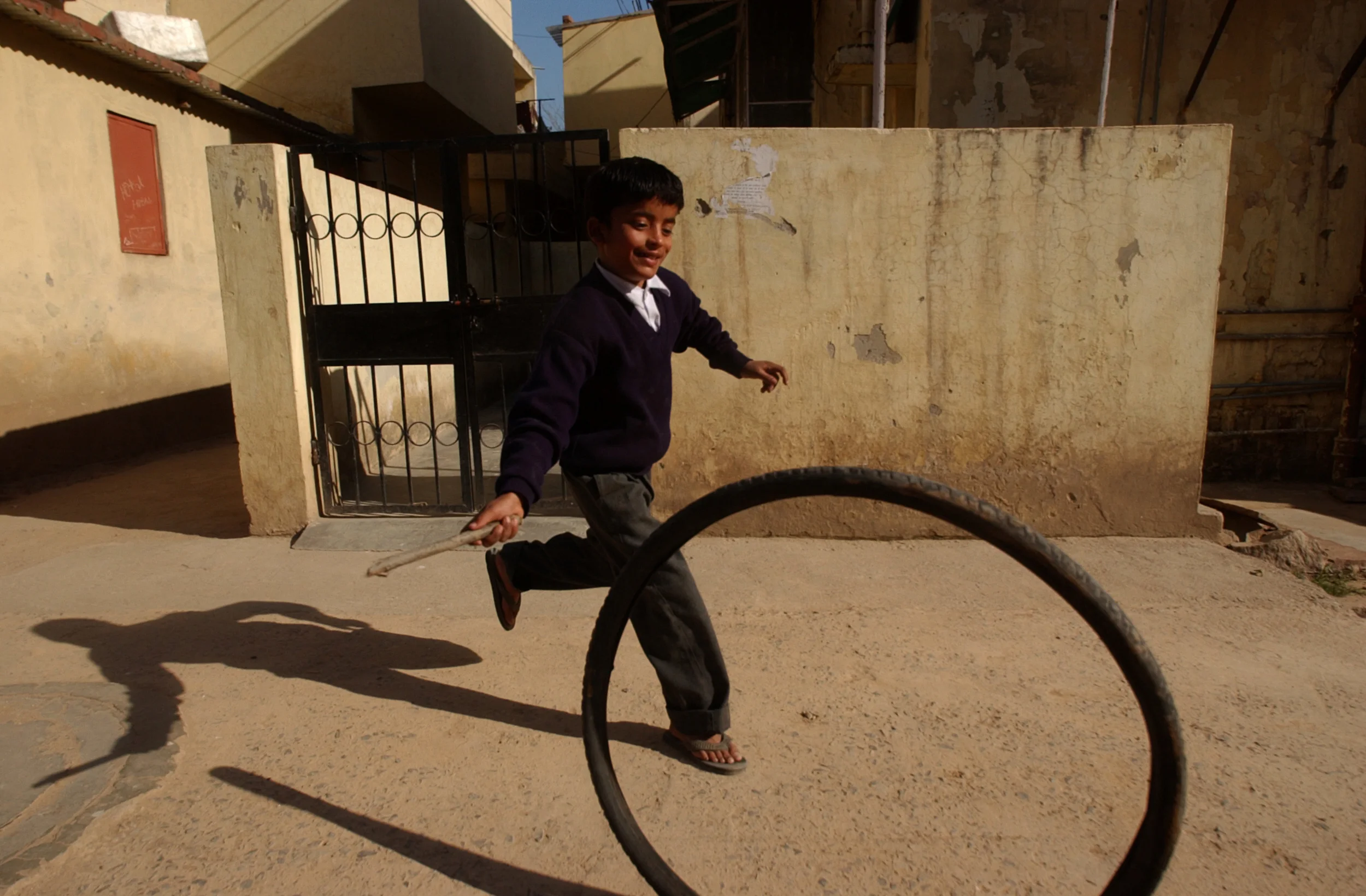 A boy plays in the street of Muzzafarnager, India in February 2005.