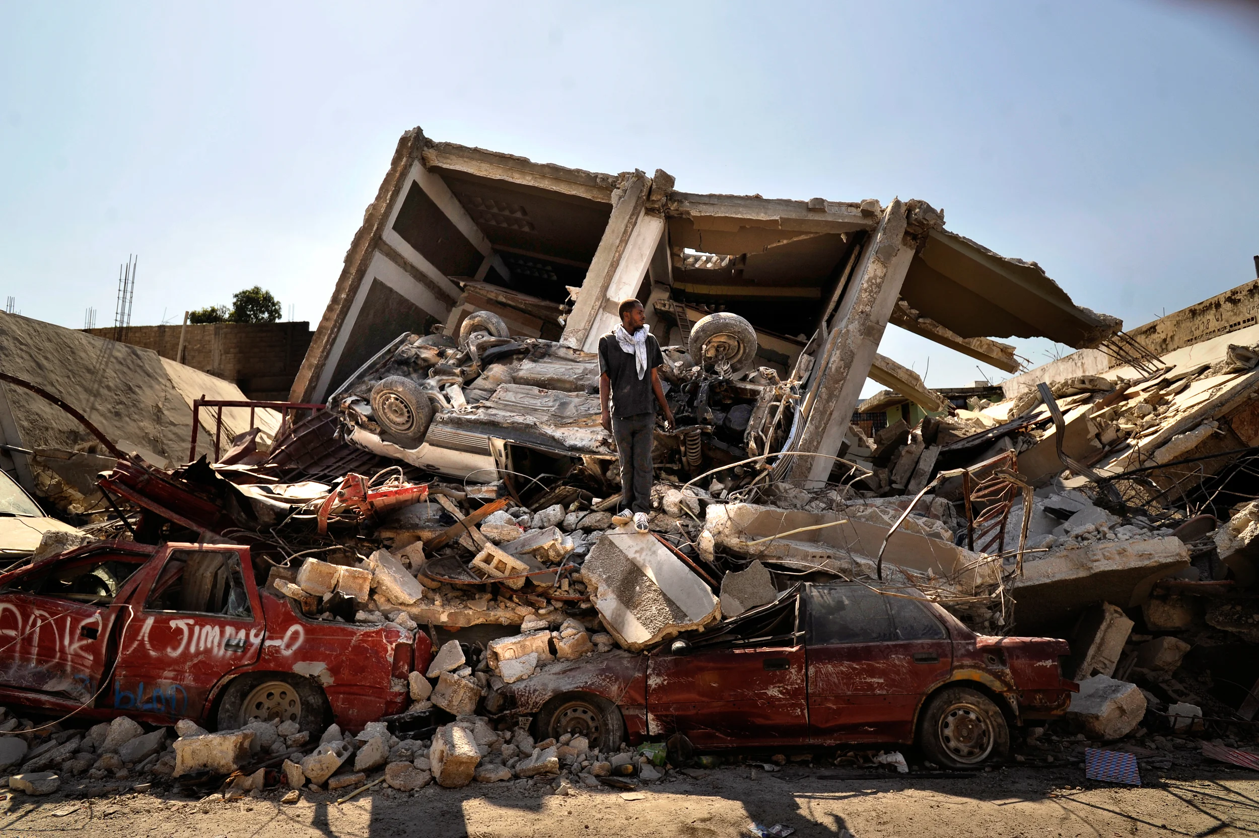 A man stands in the rubble of a building days after a devastating earthquake struck in Port-au-Prince, Haiti.