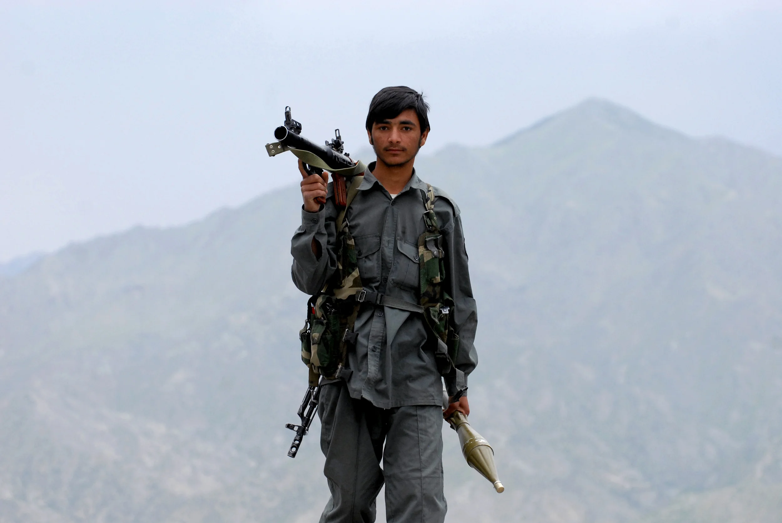 An Afghan National Police officer holds a rocket propelled grenade launcher as he stands watch on top of a hillside in Kutchyan, a small village in the Khost Province of Afghanistan, during a joint mission with the U.S. Army's 101st Airborne Divisions in May 2008.