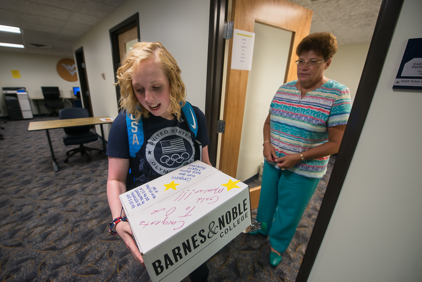 Ginny at West Virginia University, picks up her books from Sandy Cole-DeMent on Wednesday, Aug. 17, 2016.
