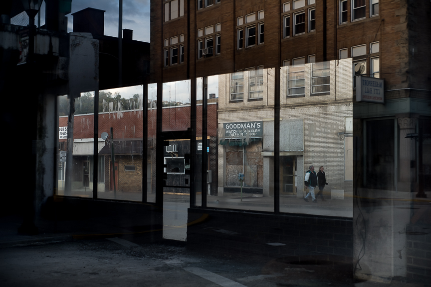 Vacant business are reflected in an empty storefront in McKeesport, Pa., on Oct. 25, 2016.