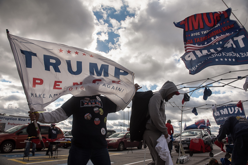 Andy Stafford, a vendor from Sarasota, Florida, holds a Trump flag as he sets up his stand in the parking lot of the International Exposition Center prior to a campaign stop by Republican presidential nominee Donald Trump on October 22, 2016 in Cleveland, Ohio. "I'm a Trump lover," says Stafford. 