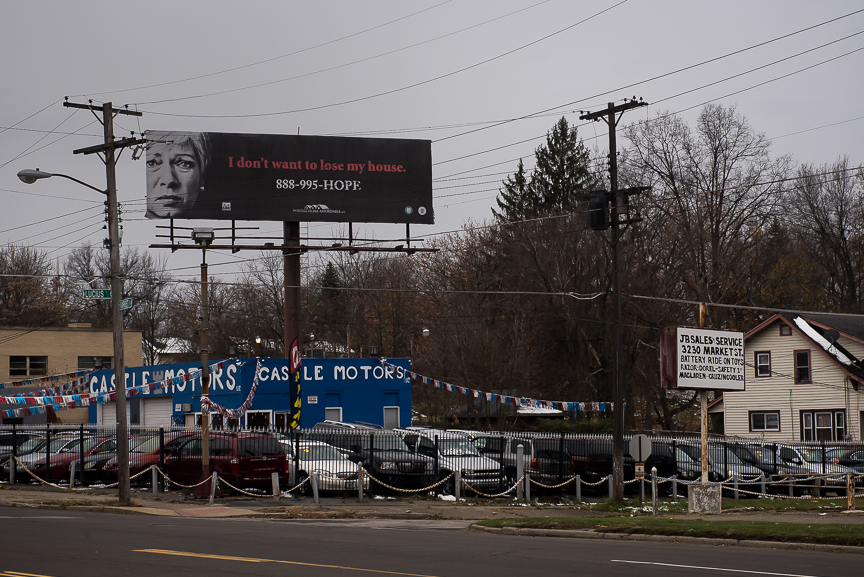 A billboard advertising protection for people losing their homes stands above a small car dealership in Youngstown, Ohio on Nov. 23, 2016.