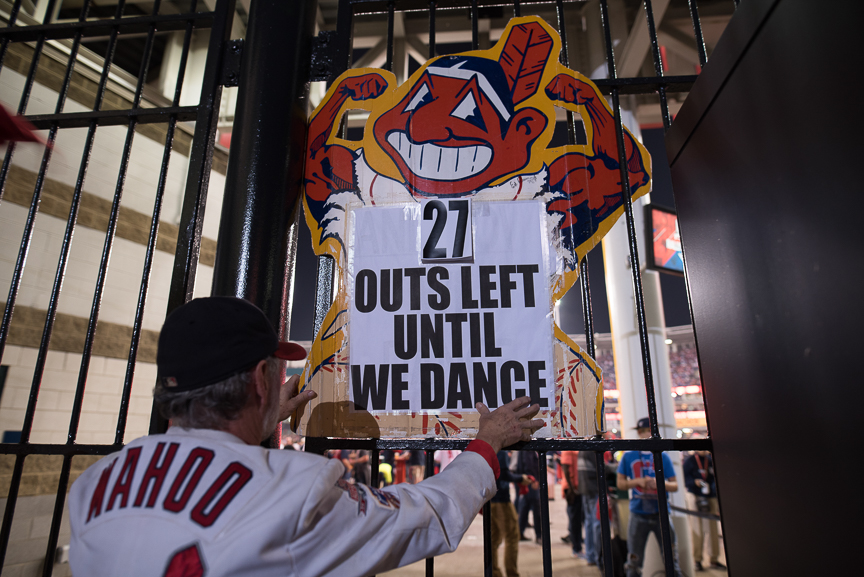 Jim Stamper of Cleveland hangs a sign outside of Progressive Field during game 6 of the World Series on November 1, 2016 in Cleveland, Ohio. 