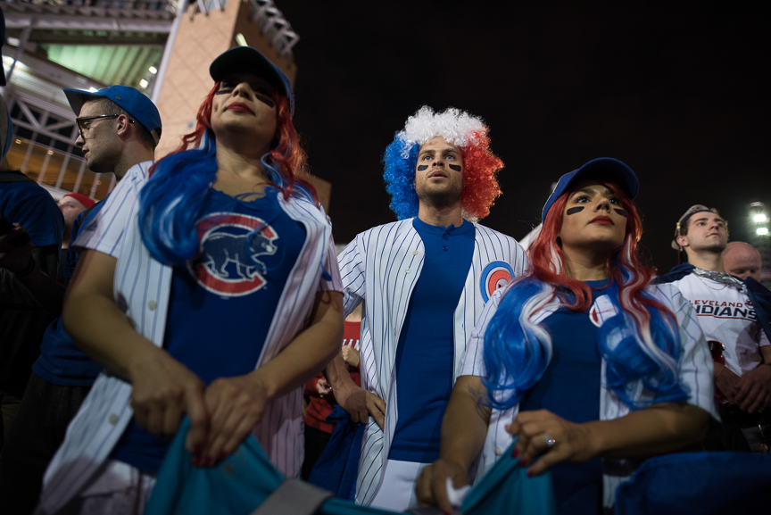 (L-R) Dayana Guzman, 38, Alex Marquez, 33, and Doraliz Guzman-Marquez, 35, all of Chicago cheer for the Cubs in outside of Progressive Field during game 7 of the World Series between the Cleveland Indians and the Chicago Cubs on November 2, 2016 in Cleveland, Ohio. 