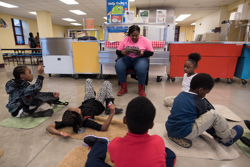 Monet Spencer reads to elementary students at Pittsburgh Miller PreK-5 on Feb. 8, 2017. She tutors at the school Mondays though Thursdays for a job through the Neighborhood Learning Alliance. 